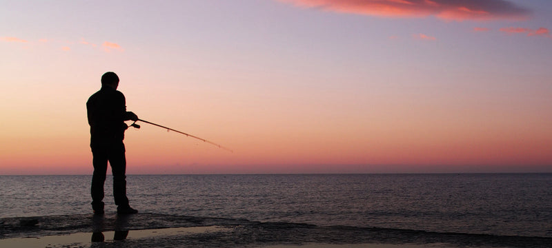 Man fishing at dusk