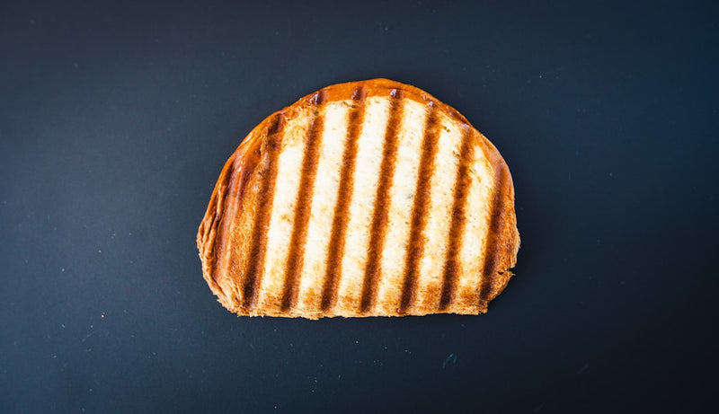brown and white bread on black surface