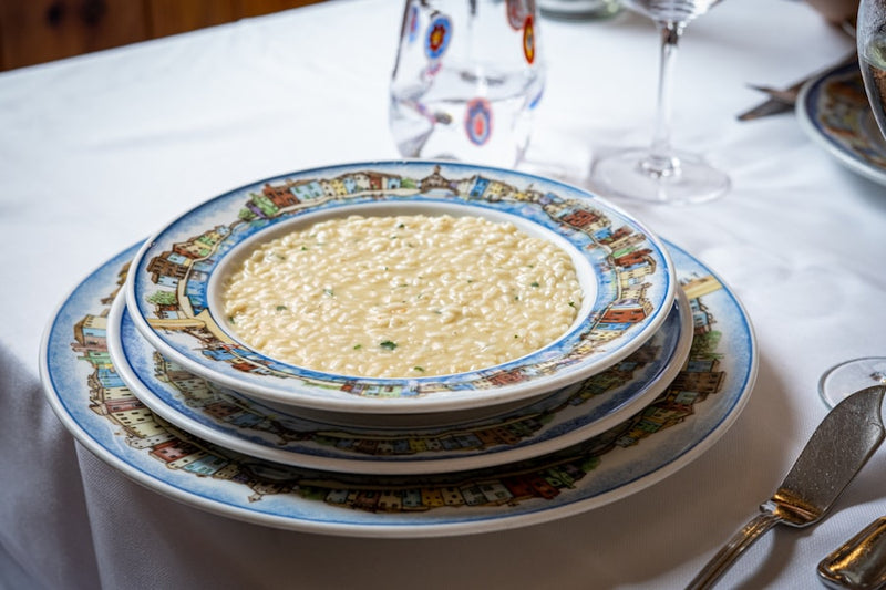 a bowl of soup on a table with silverware