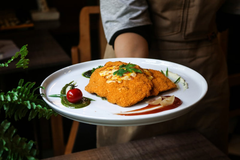 a person holding a plate with food on it