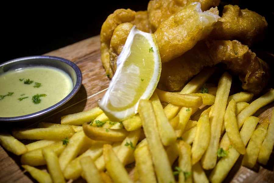 fried chicken and fries on brown wooden table