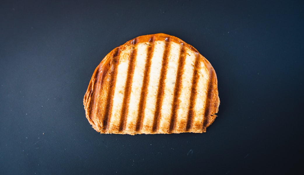 brown and white bread on black surface