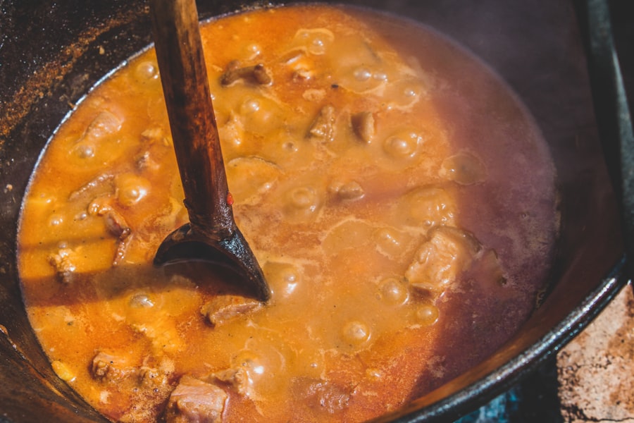 a pot of stew with a wooden spoon in it