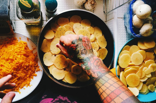a person reaching for a plate of potato chips
