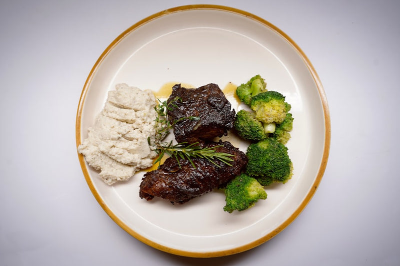 a white plate topped with meat and veggies