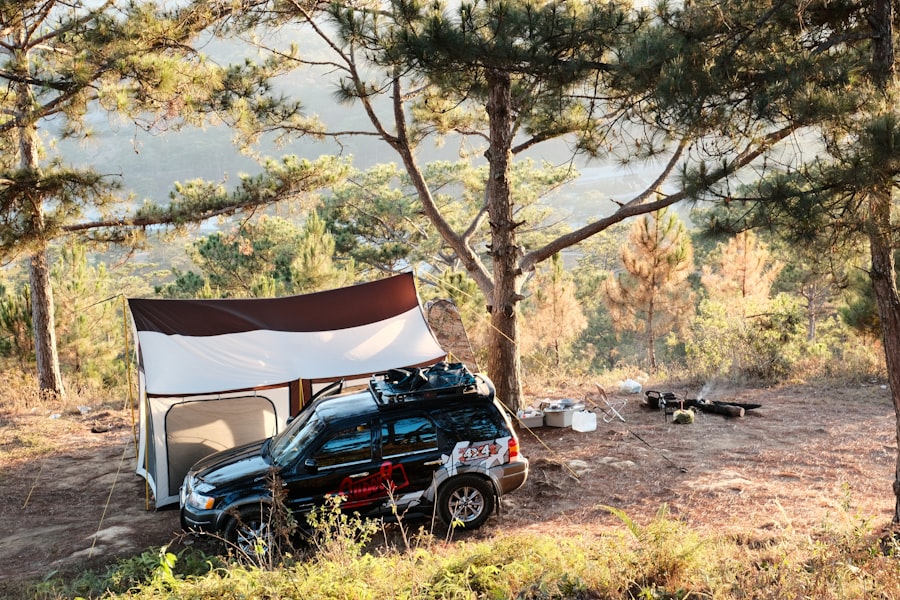 a car parked in the woods with a tent on top of it