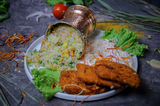Fried chicken with rice and salad on a plate