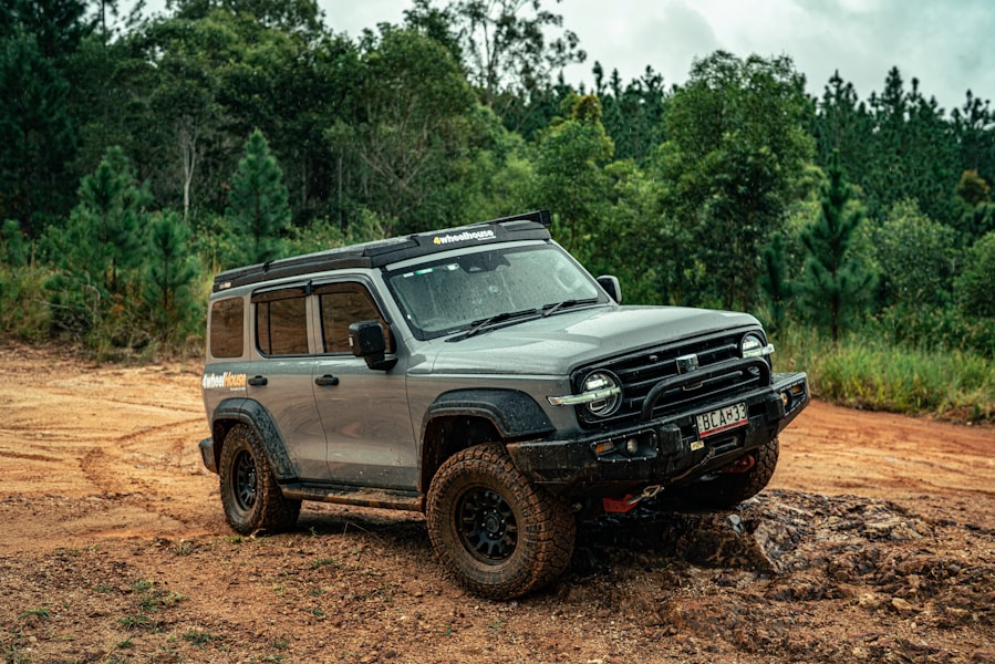 A silver off-road vehicle navigates a rocky trail.