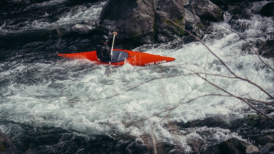 A kayaker navigates white water rapids.