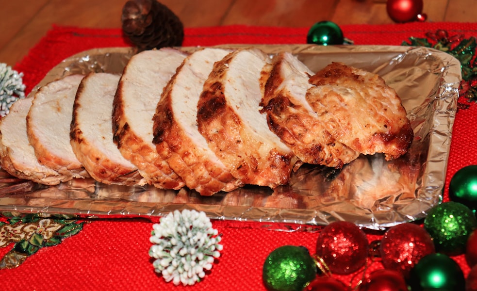 Sliced roasted turkey breast on a platter with christmas decorations