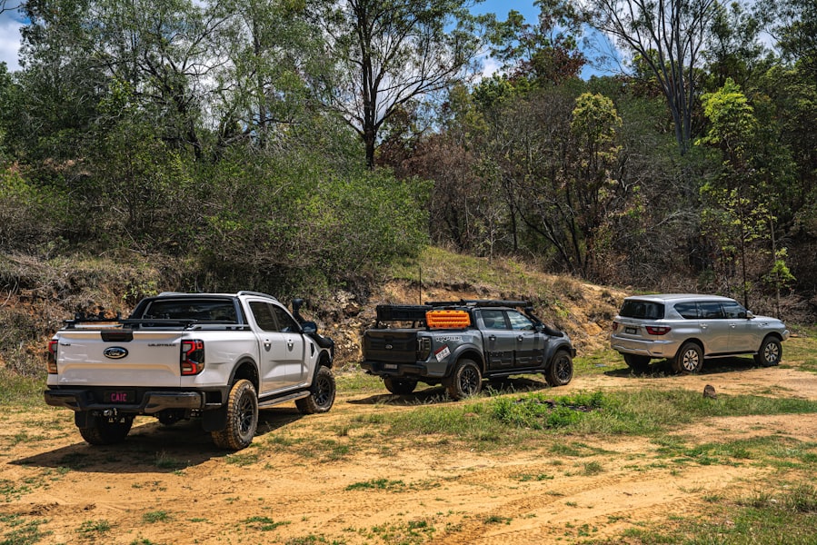 Three off-road vehicles parked on a dirt track.
