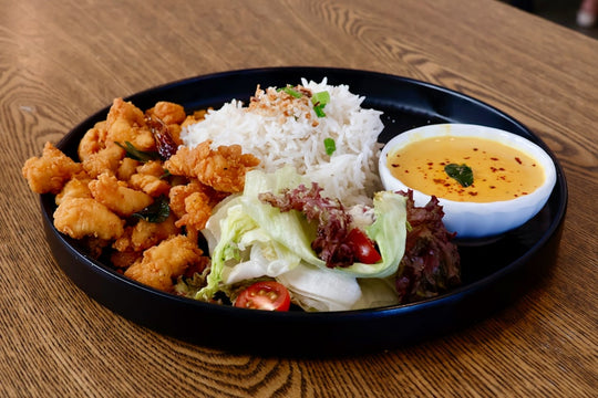 Fried chicken with rice, salad, and curry sauce