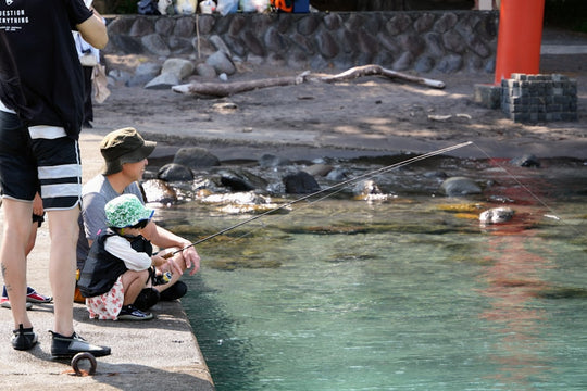 Adult and child by clear water