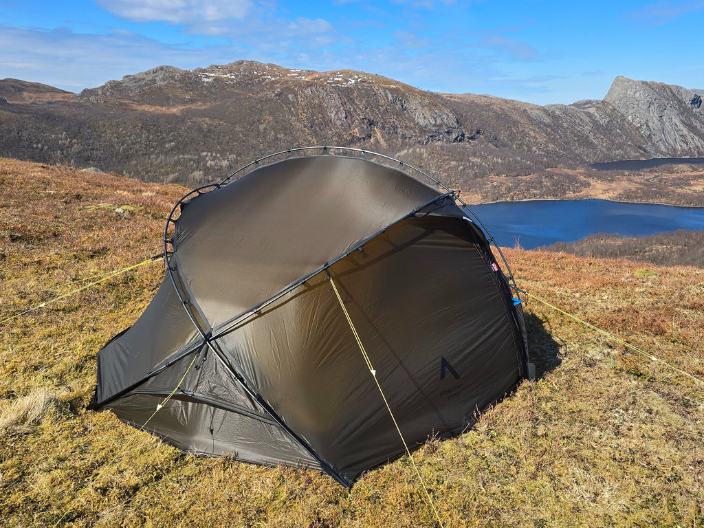 Nortent Vern 2 3S 2-person 3-season hiking tent – pitched with fly closed above a mountain lake