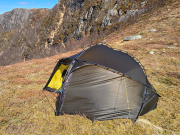 Nortent Vern 2 3S 2-person 3-season hiking tent – side view with fly closed below a rocky cliff