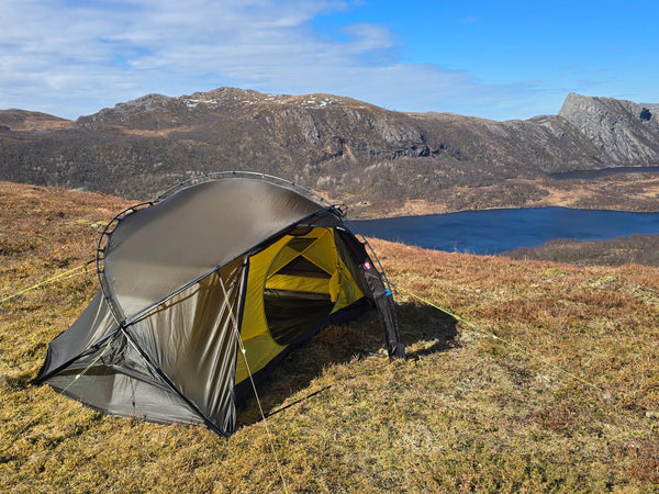 Nortent Vern 2 3S 2-person 3-season hiking tent – pitched above a lake with the vestibule door open