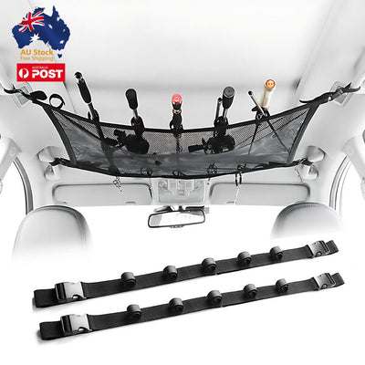 Overhead car fishing rod storage system with black straps holding multiple fishing rods against vehicle roof interior