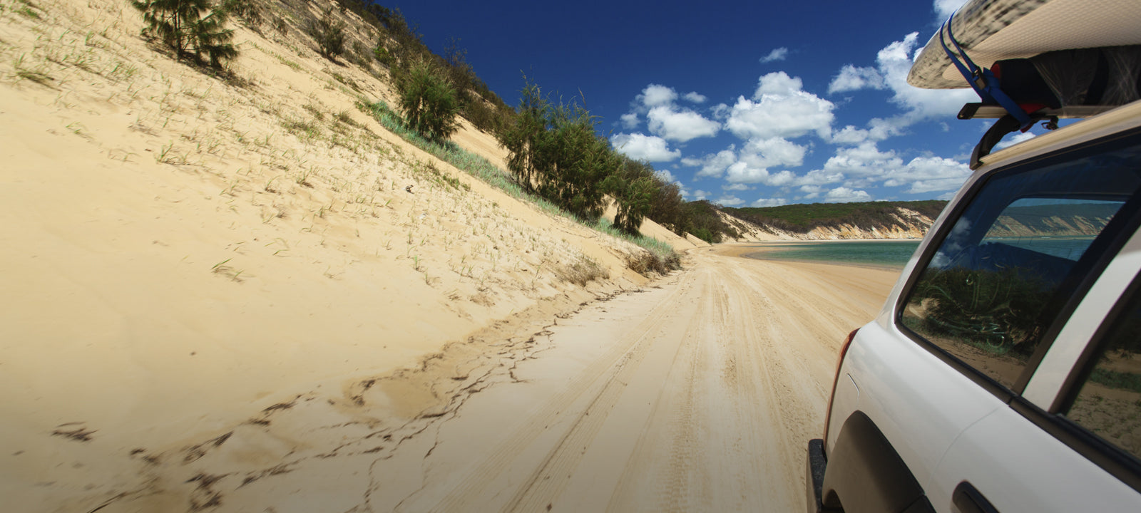Four-wheel drive on a Western Australian beach, tyres aired down for soft sand