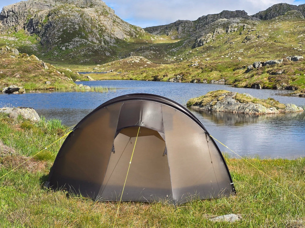 Nortent Ly 1 3S tunnel tent pitched beside a mountain tarn